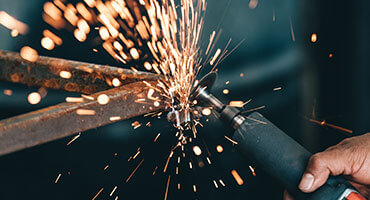 Welding a used tire recycling machine for a customer.