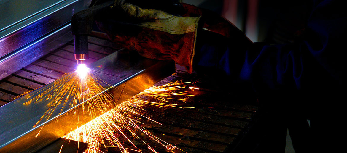 Barclay employee fixing a used shredder machine made for recycling tires
